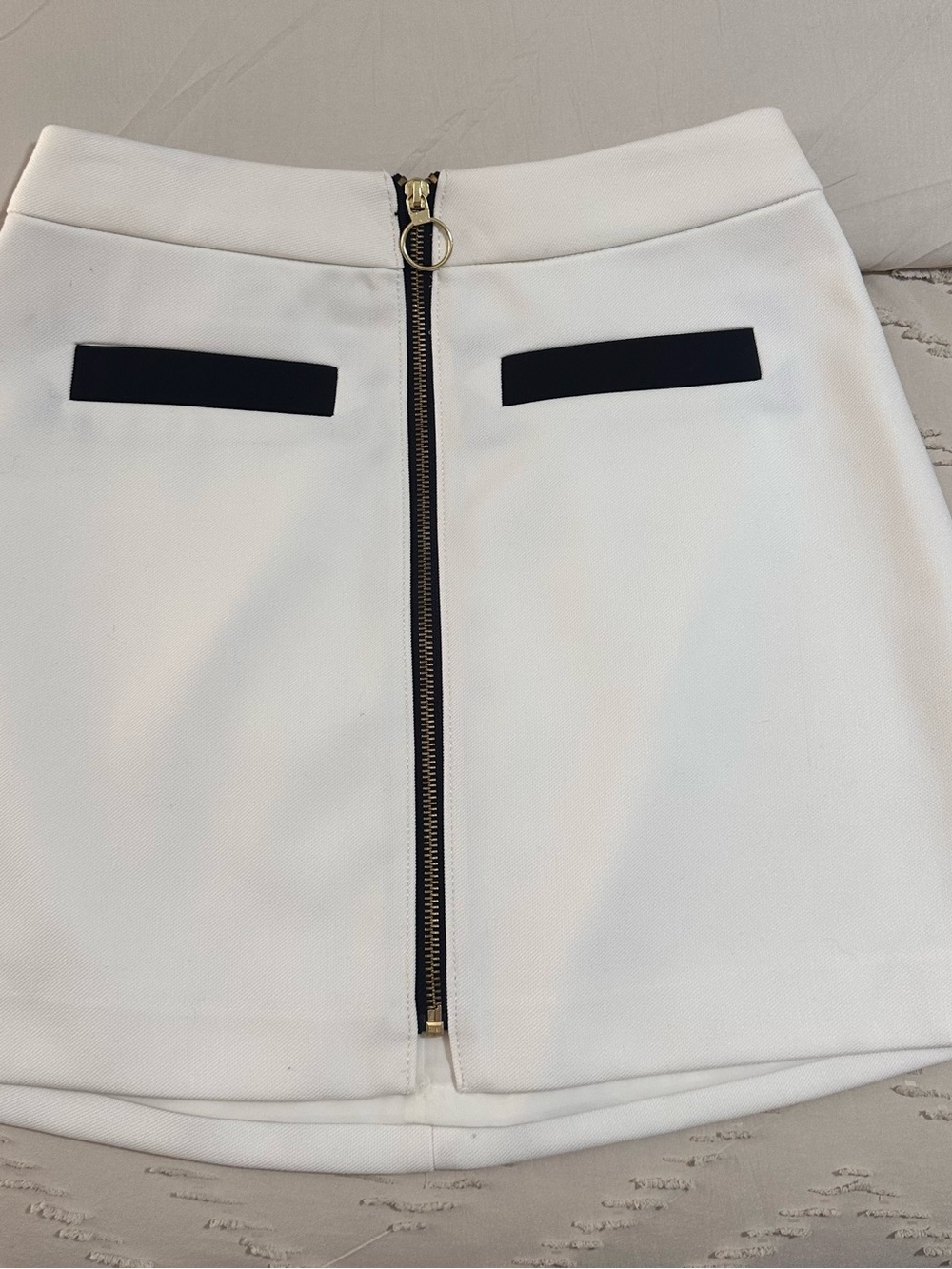 Express White Mini Skirt with Center Gold Zip and Black Pocket Accents